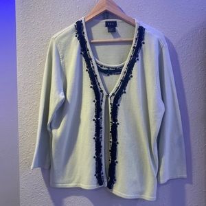 light green cardigan with matching layer underneath
and black beaded detailing.